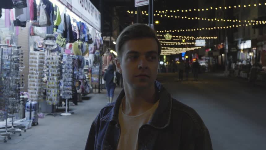 A man walks in a city at night