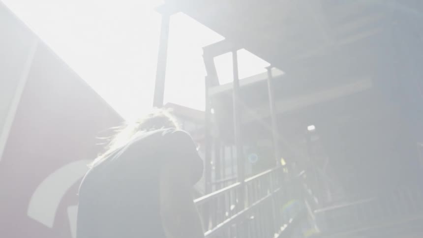 A person climbs stairs towards a landing