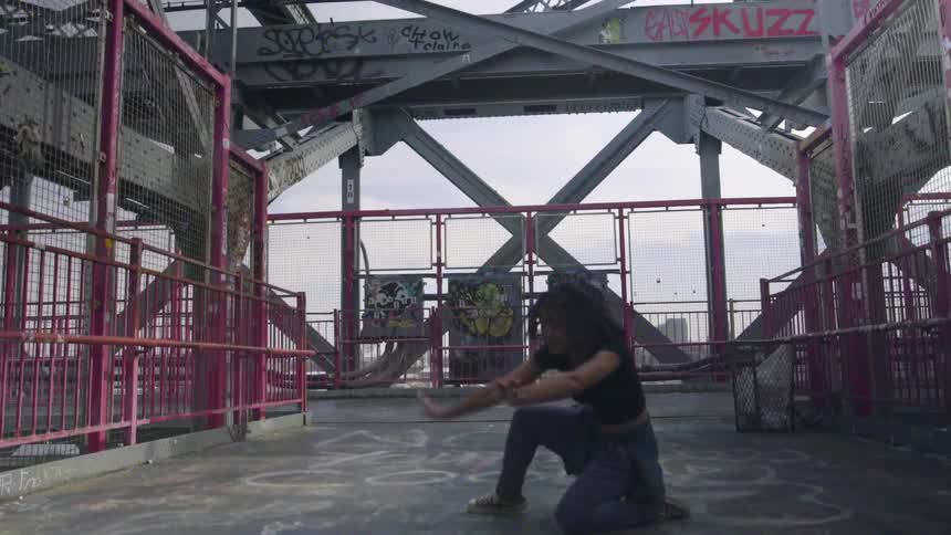 A woman is dancing on a platform