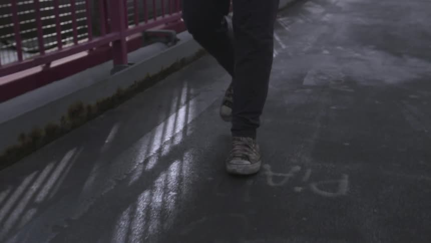 A person's feet can be seen walking