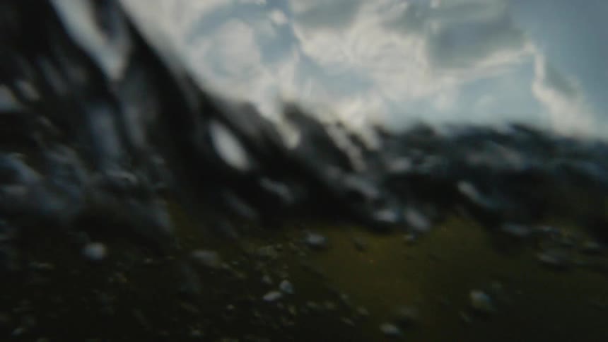 A man on a surfboard in the ocean