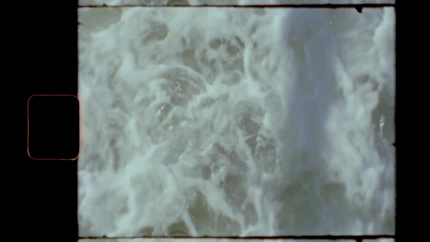 Foamy sea waves break against the coast