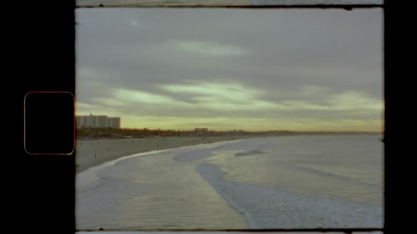 Vintage film footage of waves rolling in to the shore