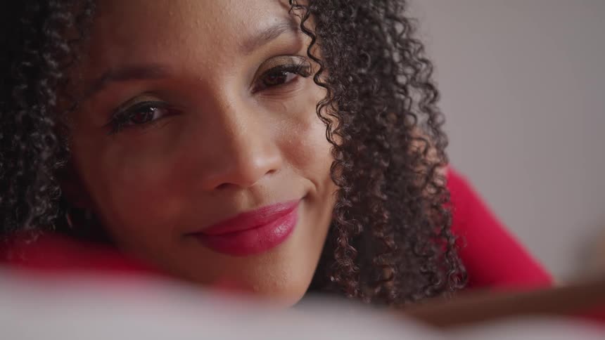 A woman is smiling indoors
