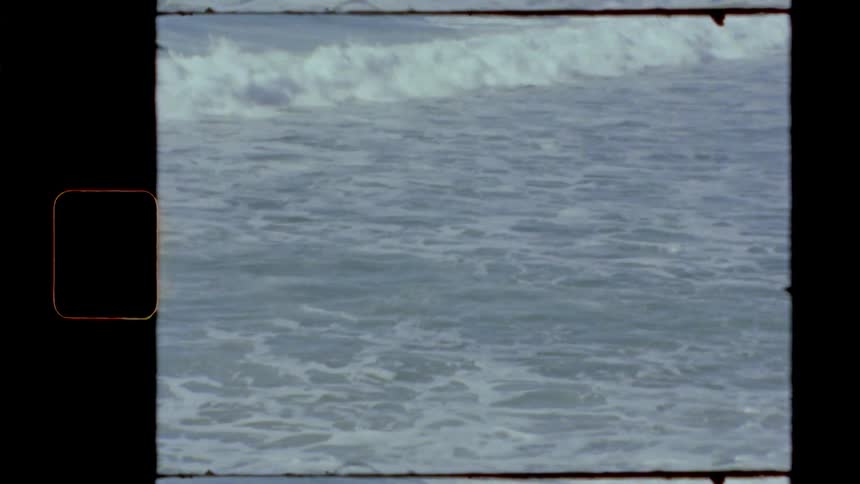 Foamy ocean waves crash against the shore