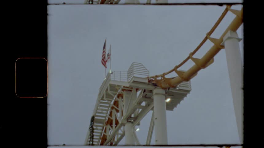 American flag flies over roller coaster structure