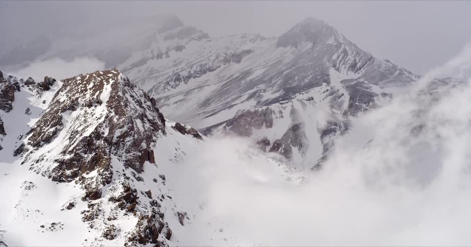 Clouds flow over the mountain top