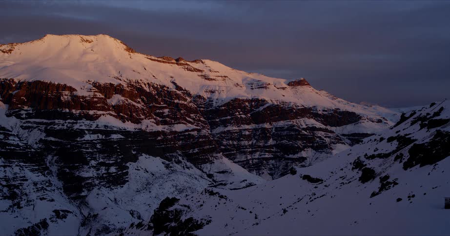 Sunset on a snowy mountain canyon in Andes Timelapse