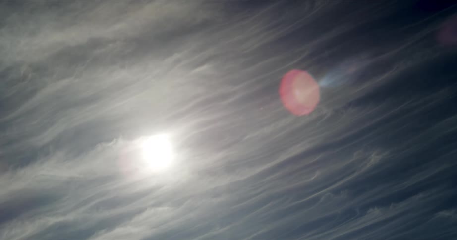 Clouds stream over a sunny sky in timelapse
