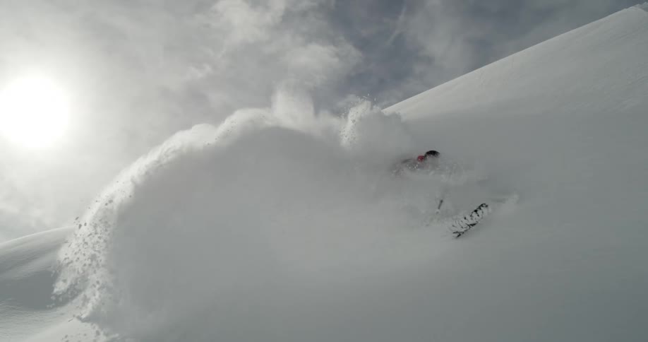 A skier glides through deep powder