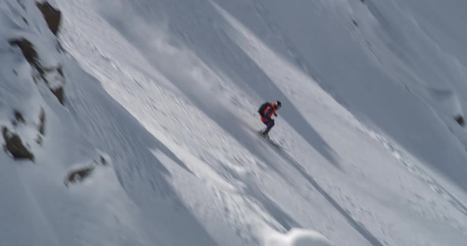 A man skiing quickly through steep rocks