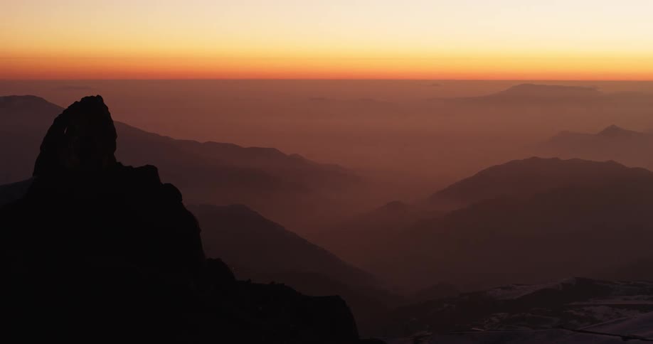 Peaks on top of a mountain range as the sun sets
