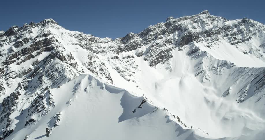 A tall mountain is covered with snow