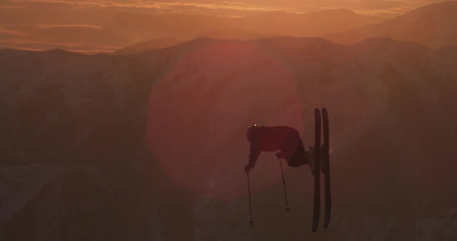 A skier backflips into the setting sun