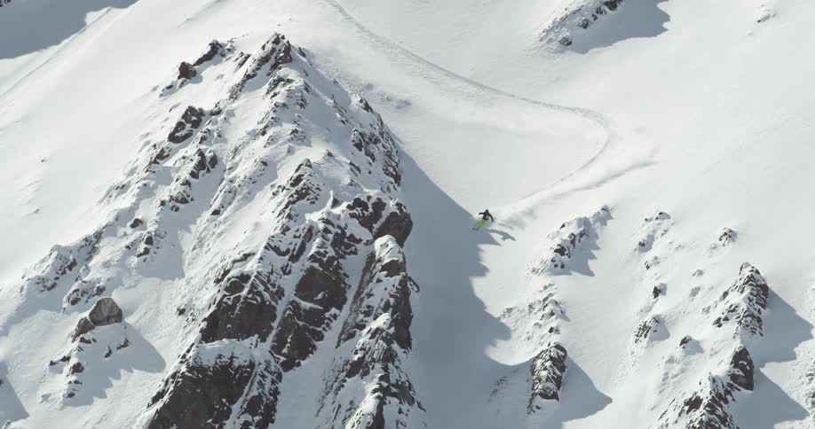 A skier blasts through a steep mountain run