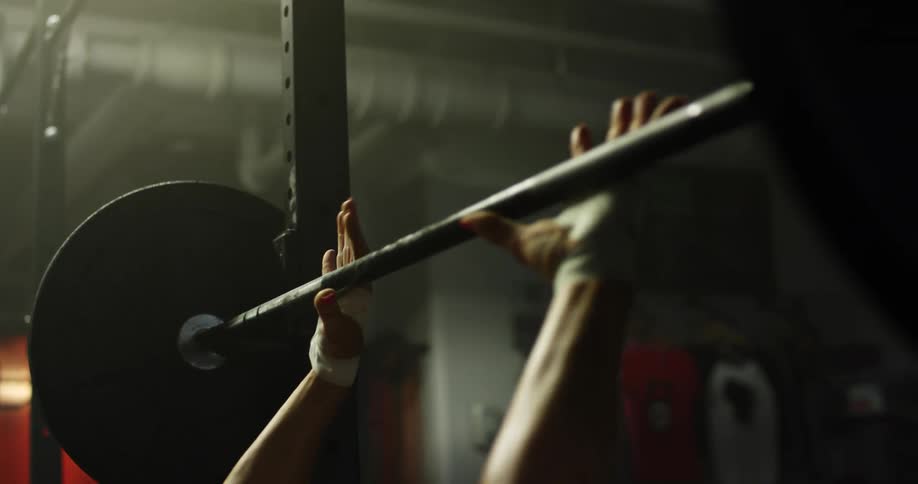 A man is lifting weights in a gym