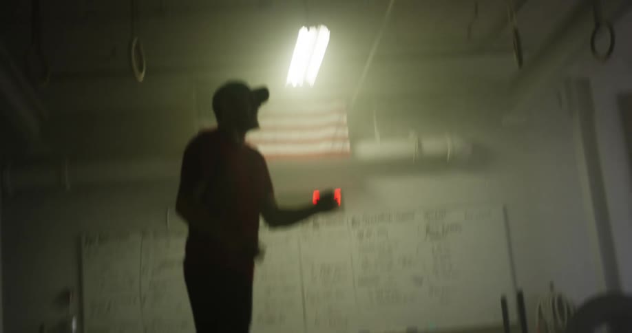 A man is exercising with a rope indoors