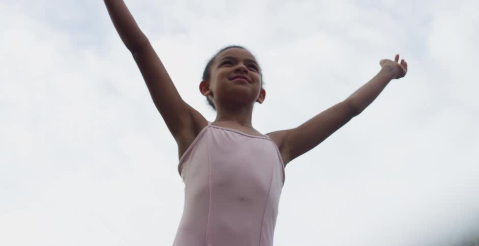 A child is doing ballet outside