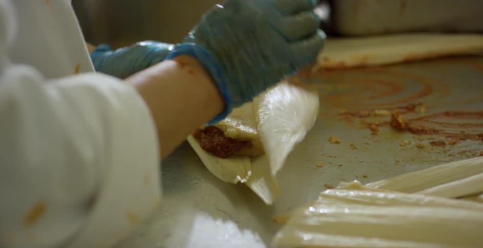 A woman cooking in a restaurant kitchen