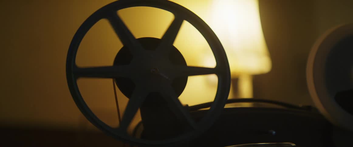 Filming playing on a movie projector in a room