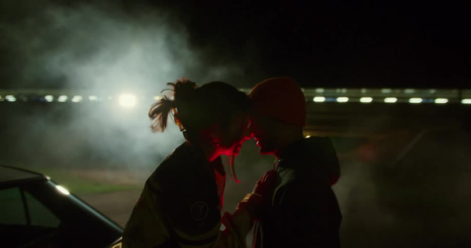 A man and a woman close to each other snuggling and smiling