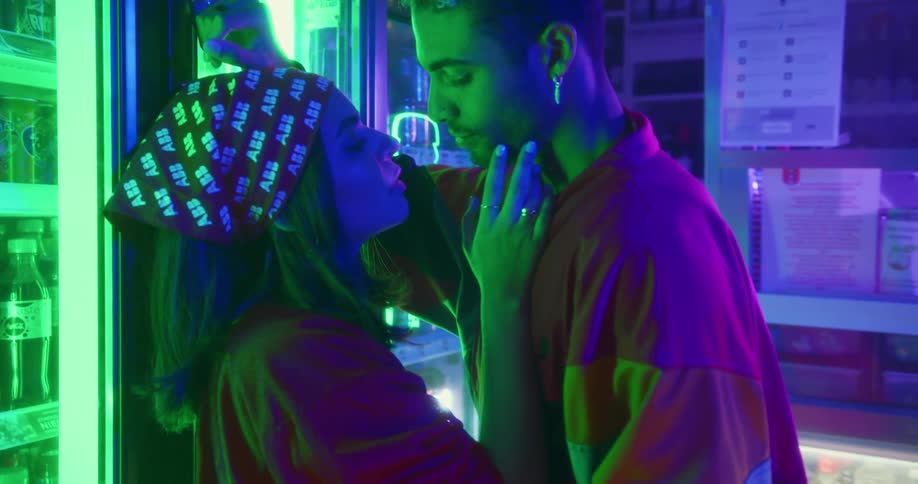 A couple inside a store hugging and caressing each other