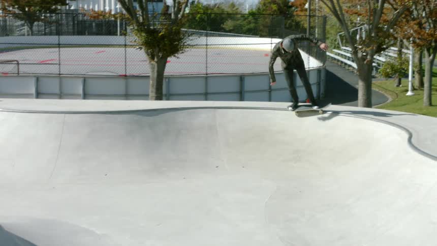 A man is skateboarding in a park