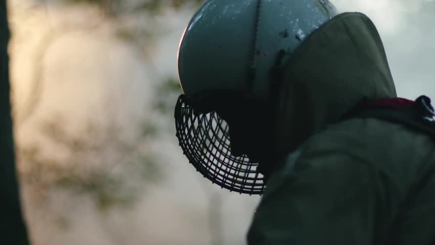 A man standing outside with a helmet and mask on
