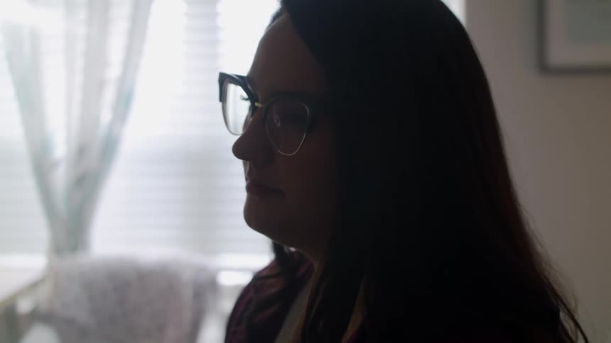 A woman is sitting in a living room
