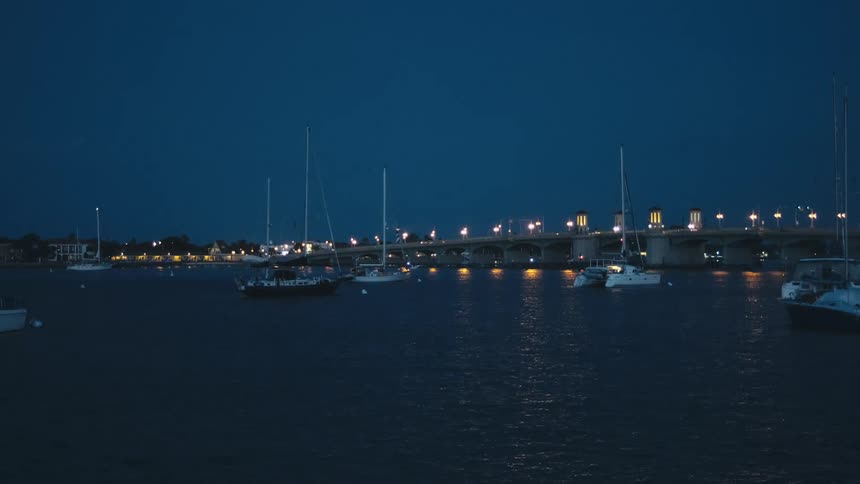 A boat dock and river with boats parked on the water