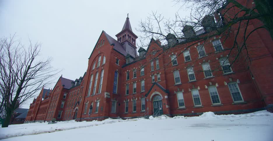 A brick university building on an overcast winter day