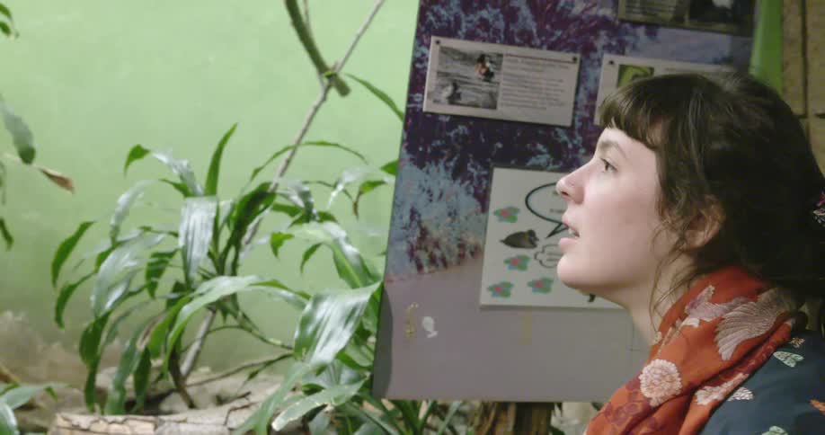 A woman looks around at an exhibit