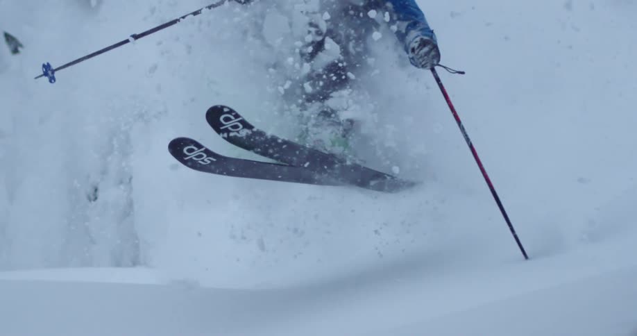 A man skis through extremely deep powder