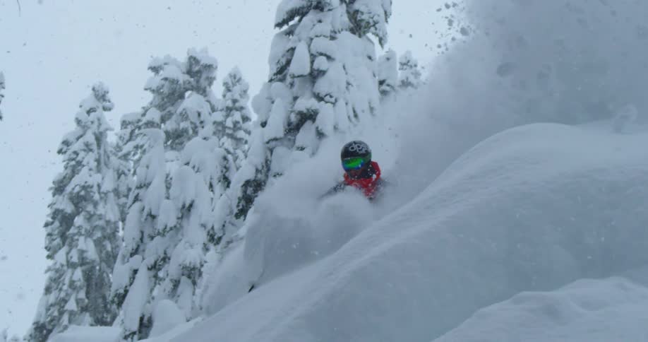 A skier turns through insanely deep powder