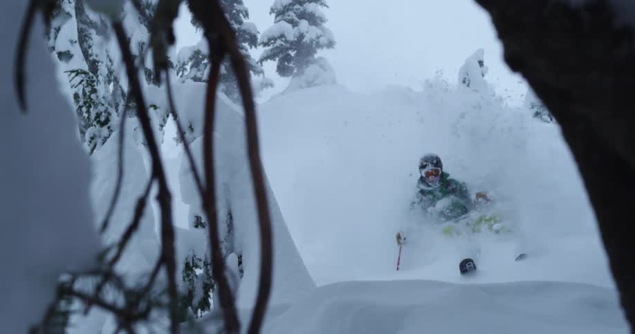 A skier does a 360 spin into deep powder