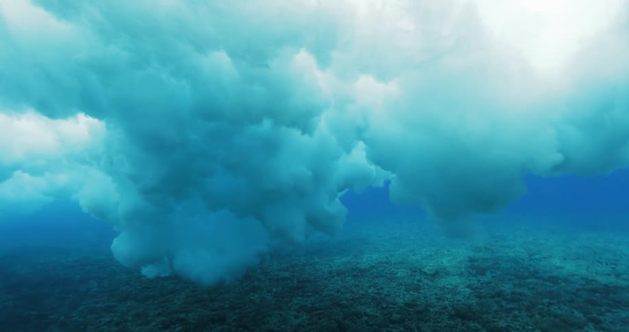 Waves boil through clear ocean water