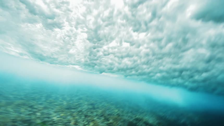 Strong waves sweep over coral reef in the ocean