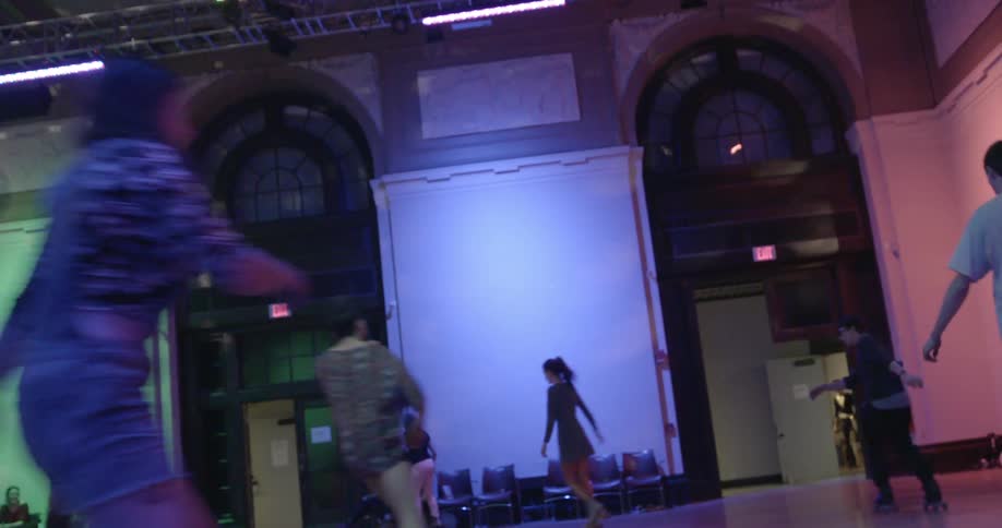 People skate inside a building