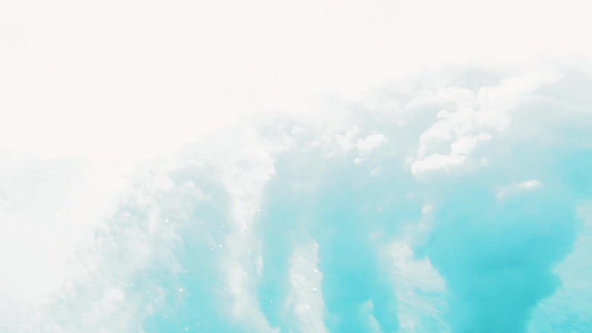 A wave rolls directly overhead distorting the ocean light