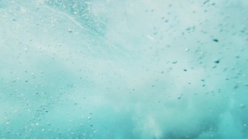 A large wave rolls over the camera