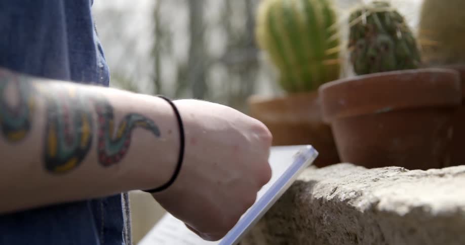 Close up of a person standing near cactus