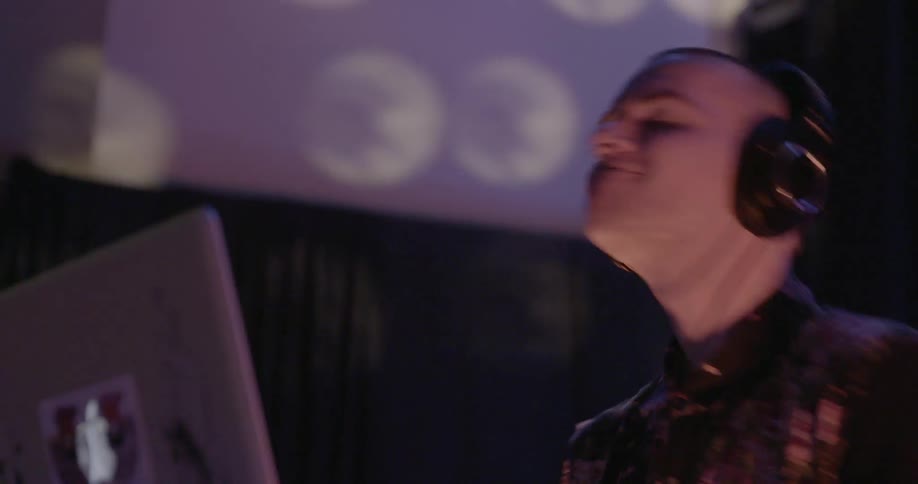A man is dancing as he dj's