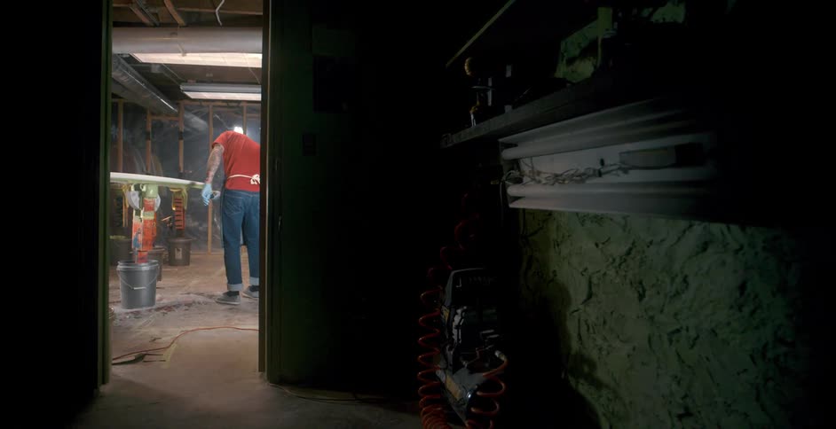 A man is working at night in his workshop