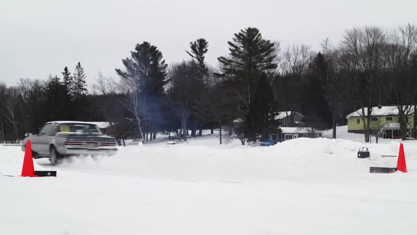A car takes off to race in the snow