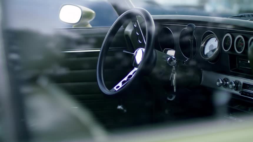 Car keys sit in ignition of car with grey interior