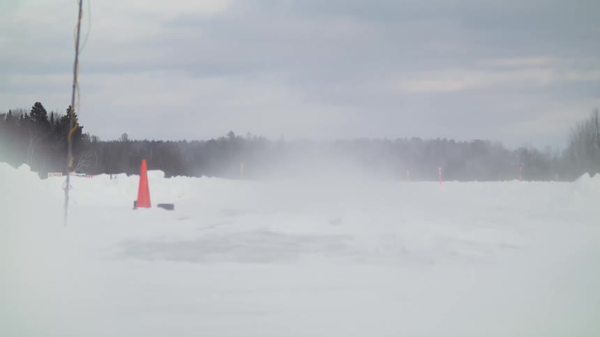A person driving a recreational vehicle in the snow
