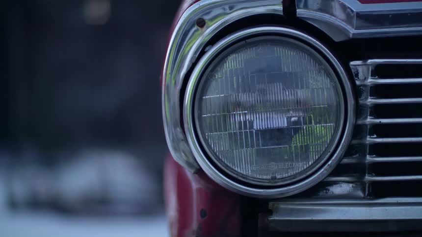 A round headlight on a parked car