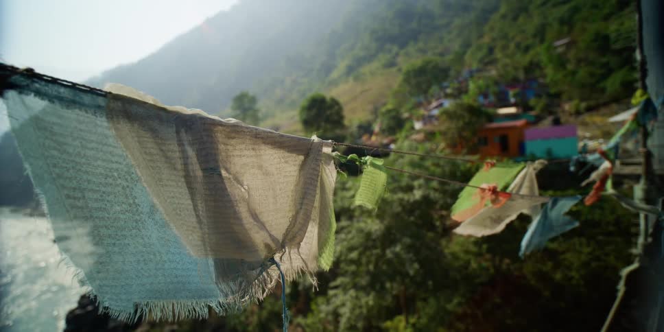 Clothes hanging on a clothesline in a rural area with the shore below