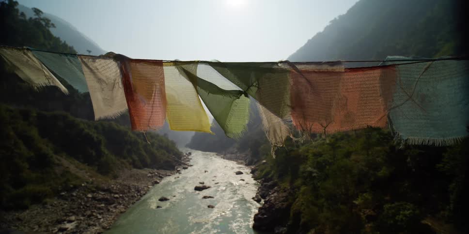 A line of flags flying over a river valley