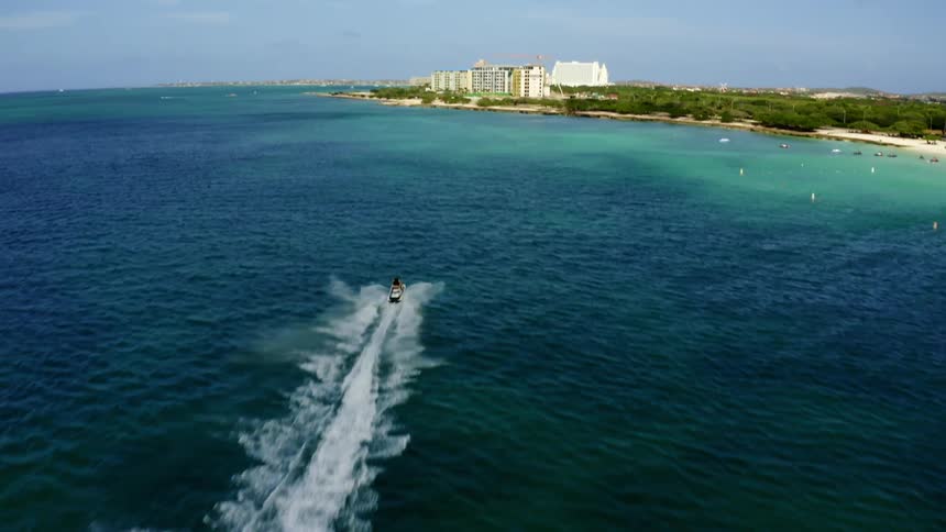 A person riding a jet ski on the water near a beach